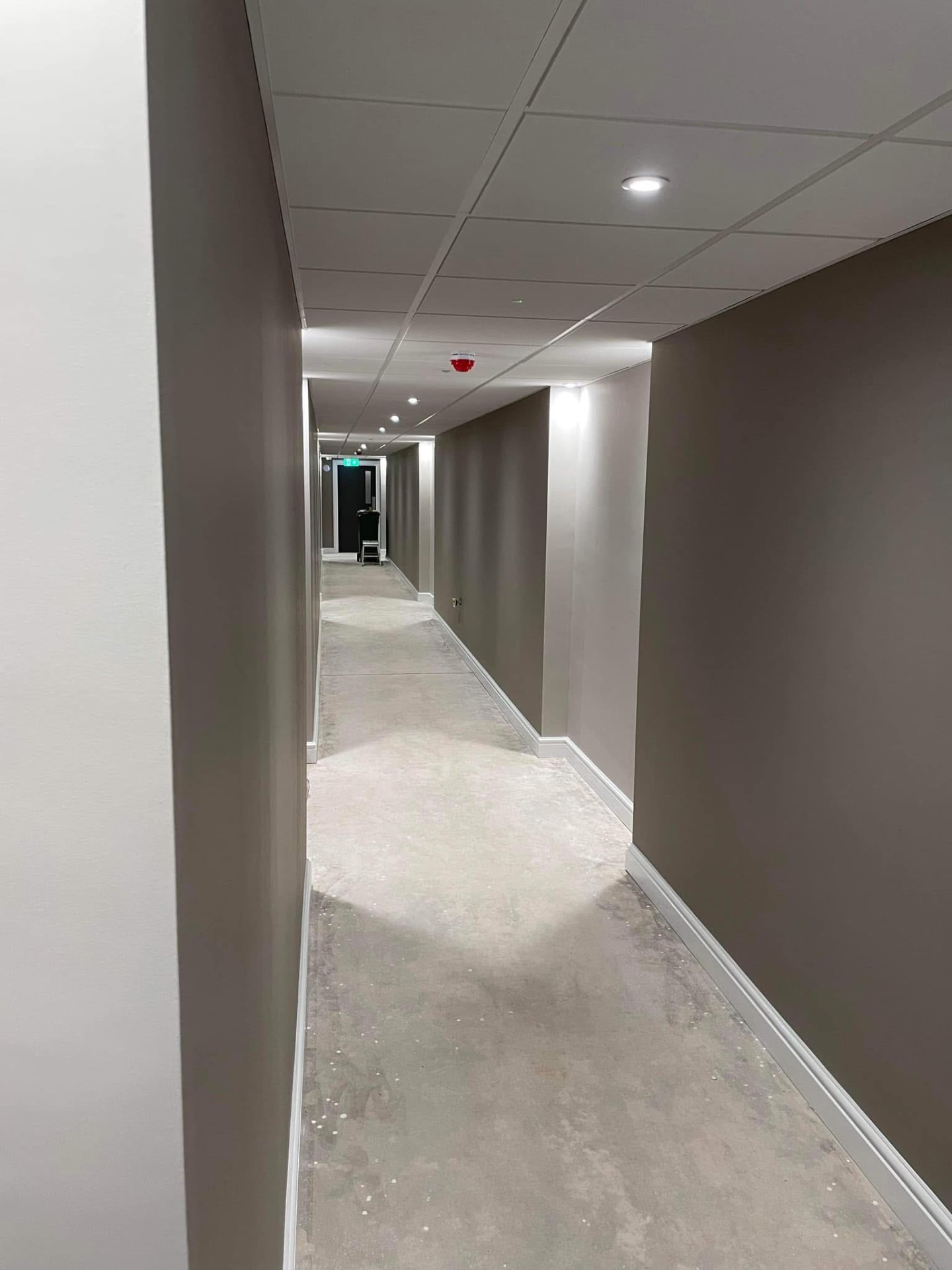 Freshly painted corridor with neat cut-in lines between walls, ceiling and skirting