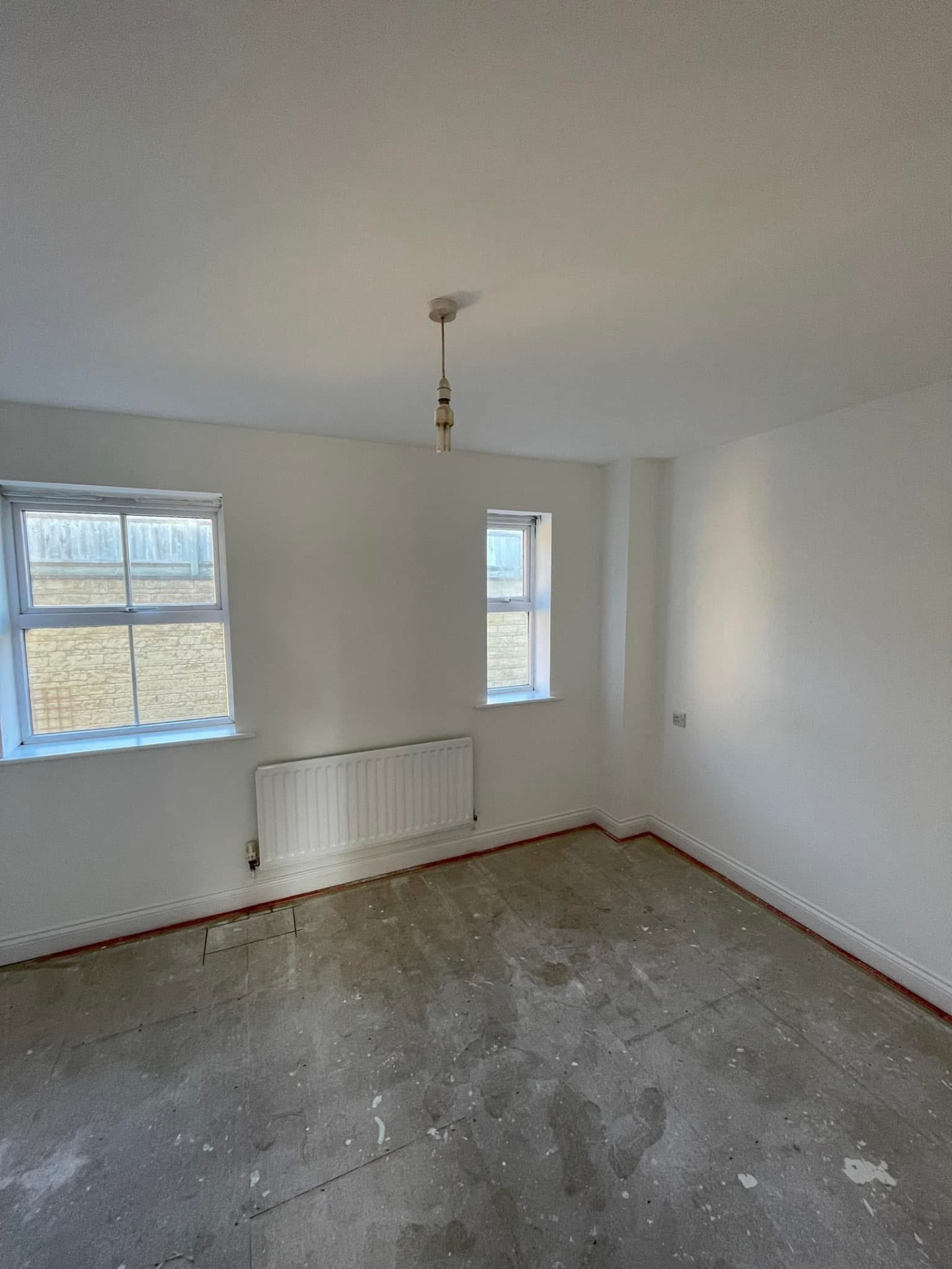 Bedroom with a repaired ceiling painted in a crisp uniform off-white